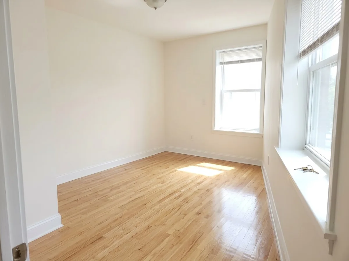 Empty apartment room with shining hardwood floors and house keys on the windowsill after a move out cleaning